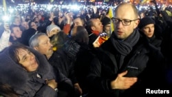 Ukrainian opposition leader Arseniy Yatsenyuk (right) joins antigovernment protesters in the singing of the Ukrainian national anthem at the "Euromaidan" encampment on Independence Square in Kyiv in mid-December.
