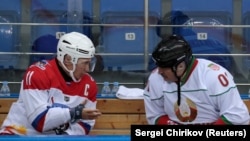 RUSSIA -- Russian President Vladimir Putin speaks with Belarusian President Alyaksandr Lukashenka (Right) during a hockey game at Shayba Arena in the Black Sea resort of Sochi, Russia February 15, 2019