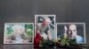 Photographs of journalists Orkhan Dzhemal (right), Kirill Radchenko (center) and Aleksandr Rastorguyev are seen at a small memorial to the slain jounalists outside the Central House of Journalists in Moscow.
