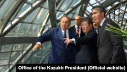 Қазақстан президенті Нұрсұлтан Назарбаев EXPO көрмесі аумағында тұр. Сол жағында "Астана ЭКСПО" ұлттық компаниясының басшысы Ахметжан Есімов. 1 маусым 2017 жыл.