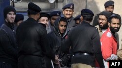 Pakistani police escorted the U.S. defendants as they arrived at an antiterrorism court in Sargodha in February.