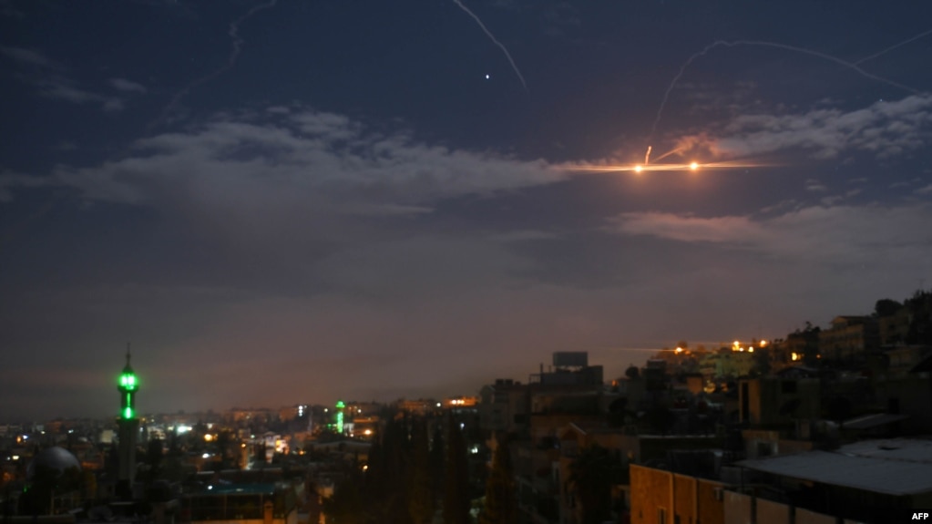 A picture taken early on January 21, 2019 shows Syrian air defense batteries responding to what the Syrian state media said were Israeli missiles targeting Damascus.