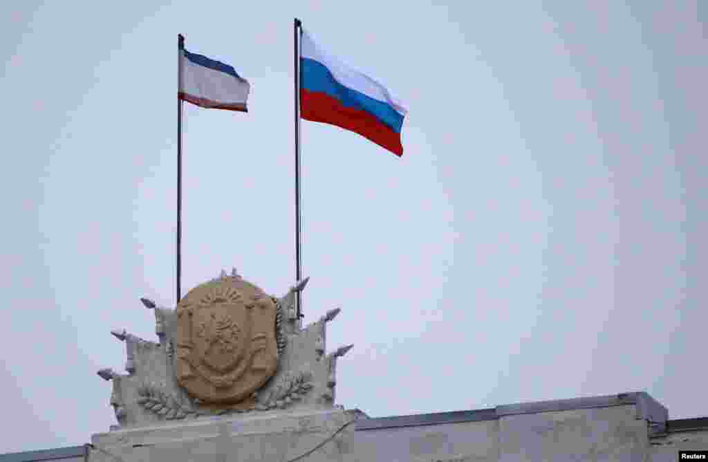 1 марта 2014 года, над Верховным советом Автономной Республики Крым развевается российский флаг. Он появился здесь несколькими днями ранее, когда вооруженный спецназ в ночь на 27 февраля захватил здание Верховного совета. Российские военные не пускали в здание некоторых депутатов, к голосованию были допущены лишь часть из них. Они приняли решение отправить в отставку правительство Анатолия Могилева и назначить нового премьер-министра Крыма – Сергея Аксенова, лидера партии "Русское единство" (на тот момент в парламенте Крыма было всего три депутата от этой партии из 100). Также было принято решение о проведении "общекрымского опроса" о статусе полуострова. В голосовании, по не подтвержденным независимыми источниками данным, принимали участие 64 депутата.