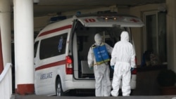 Armenia -- Workers disinfect an ambulance outside Surp Girgor Lusavorich hospital in Yerevan, April 8, 2020.