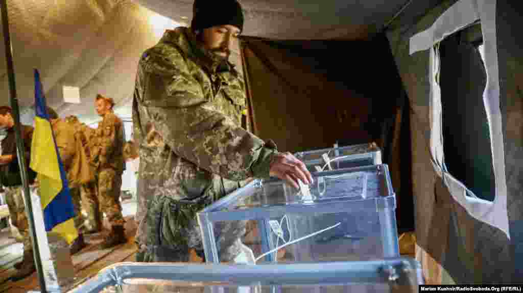 A Ukrainian soldier casts his ballot paper. The choice is between incumbent President Petro Poroshenko and political outsider Volodymyr Zelenskiy.