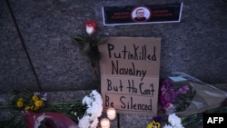 Flowers and signs are left outside the Russian Embassy in Washington on February 16 following the death of Russian opposition leader Aleksei Navalny.