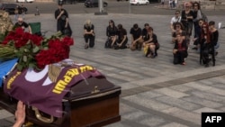 People pay their respects at the coffin of Daria Filipieva, a Ukrainian Army combat medic who was killed in the Donetsk region, during her funeral on Independence Square in Kyiv on August 12.