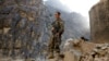 An Afghan government soldier stands guard on the Jalalabad-Kabul highway on July 8 amid recent gains made by the Taliban. 