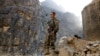 An Afghan government soldier stands guard on the Jalalabad-Kabul highway on July 8 amid recent gains made by the Taliban. 