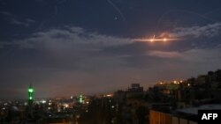 A picture taken early on January 21, 2019 shows Syrian air defense batteries responding to what the Syrian state media said were Israeli missiles targeting Damascus.