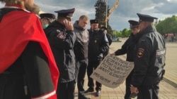 Полицейские рассматривают плакат активиста Григория Русина