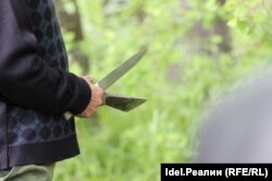 As Tanakov intoned ancient prayers in the Mari language during the ritual, another man beat a slow rhythm with an ax and a knife.