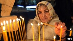 A woman lights candles at a cathedral in Sarajevo, capital of Muslim-majority Bosnia. Ethnic and religious divides remain sensitive issues in the country.