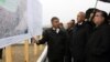 Tajik President Emomali Rahmon (right) inspects plans for the new desert city