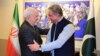 Pakistani Foreign Minister Shah Mehmood Qureshi (right) greets Iranian counterpart Mohammad Javad Zarif at the Foreign Ministry in Islamabad on May 24.