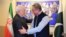 Pakistani Foreign Minister Shah Mehmood Qureshi (right) greets Iranian counterpart Mohammad Javad Zarif at the Foreign Ministry in Islamabad on May 24.