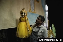 A puppeteer poses between shows in Khiva.