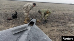 Members of a police demining unit remove a warhead from a Russian kamikaze drone in Ukraine. (file photo)