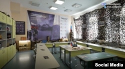 A schoolroom museum in Moscow features a memorial to a soldier.