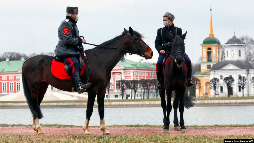 Cossack volunteers, wearing face masks to protect against the coronavirus, patrol the Palace of Kuskovo in Moscow on April 8. 