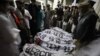 People gather around the bodies of the victims killed in an attack on the Bacha Khan University on January 20.