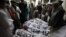 People gather around the bodies of the victims killed in an attack on the Bacha Khan University on January 20.