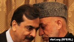 Afghan President Hamid Karzai (right) speaks with Pakistani Prime Minister Yousaf Raza Gilani in Kabul in April