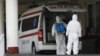 Armenia -- Workers disinfect an ambulance outside Surp Girgor Lusavorich hospital in Yerevan, April 8, 2020.