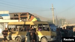 Police and fire fighters are seen at the site of a blast in Kabul on June 20.