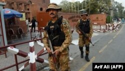 Pakistani soldiers patrol outside the cricket stadium ahead of the match between Pakistan and Sri Lanka on October 25.