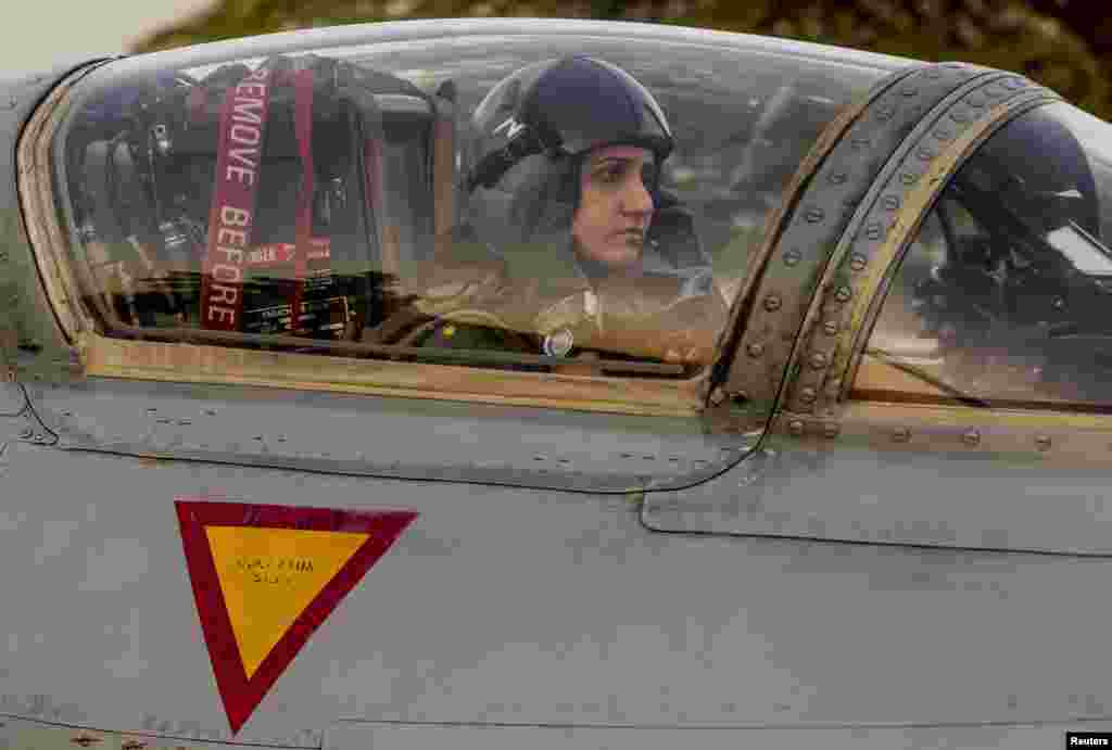 Ayesha Farooq sits in the cockpit of a Chinese-made F-7PG fighter jet at Mushaf base in Sargodha