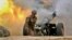NAGORN-KARABAKH -- A serviceman of Karabakh's Defence Army fires an artillery piece towards Azeri positions during fighting over the breakaway Nagorno Karabakh region, September 28, 2020
