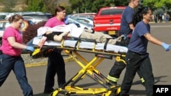 Authorities move a shooting victim after a gunman opened fire at Umpqua Community College in a shooting that killed nine people in Roseburg, Oregon, on October 1.