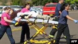 Authorities move a shooting victim after a gunman opened fire at Umpqua Community College in a shooting that killed nine people in Roseburg, Oregon, on October 1. 