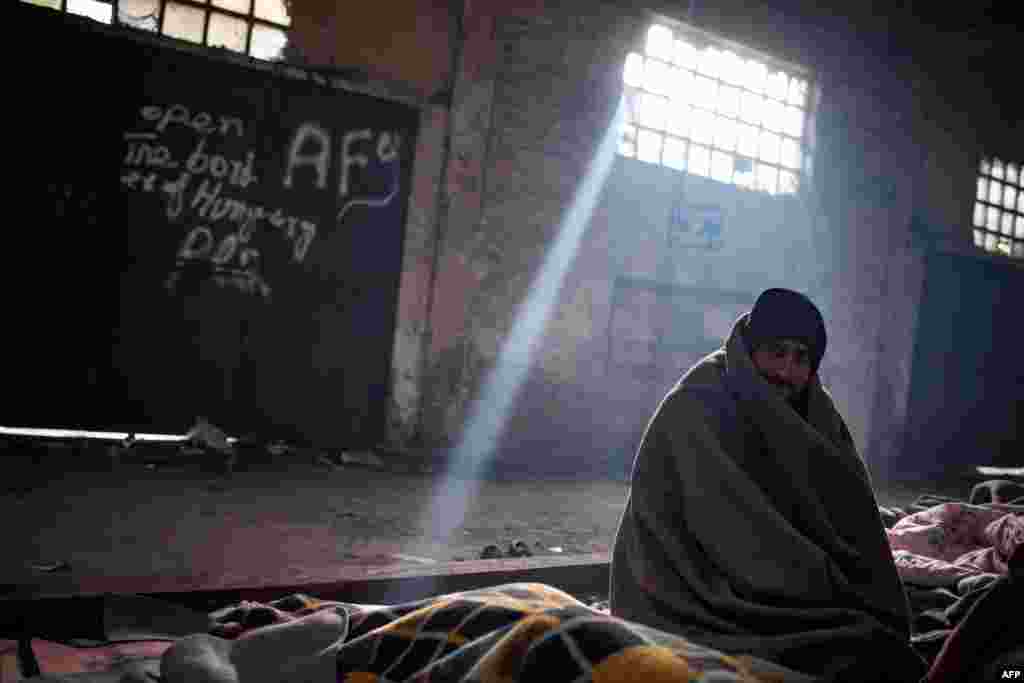 A Pakistani migrant sits in a makeshift shelter in an abandoned warehouse in Belgrade. (AFP/Andrej Isakovic)