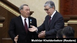 Acting Kazakh President Qasym-Zhomart Toqaev (right) and his predecessor, Nursultan Nazarbaev, attend a joint session of parliament in Astana on March 20.