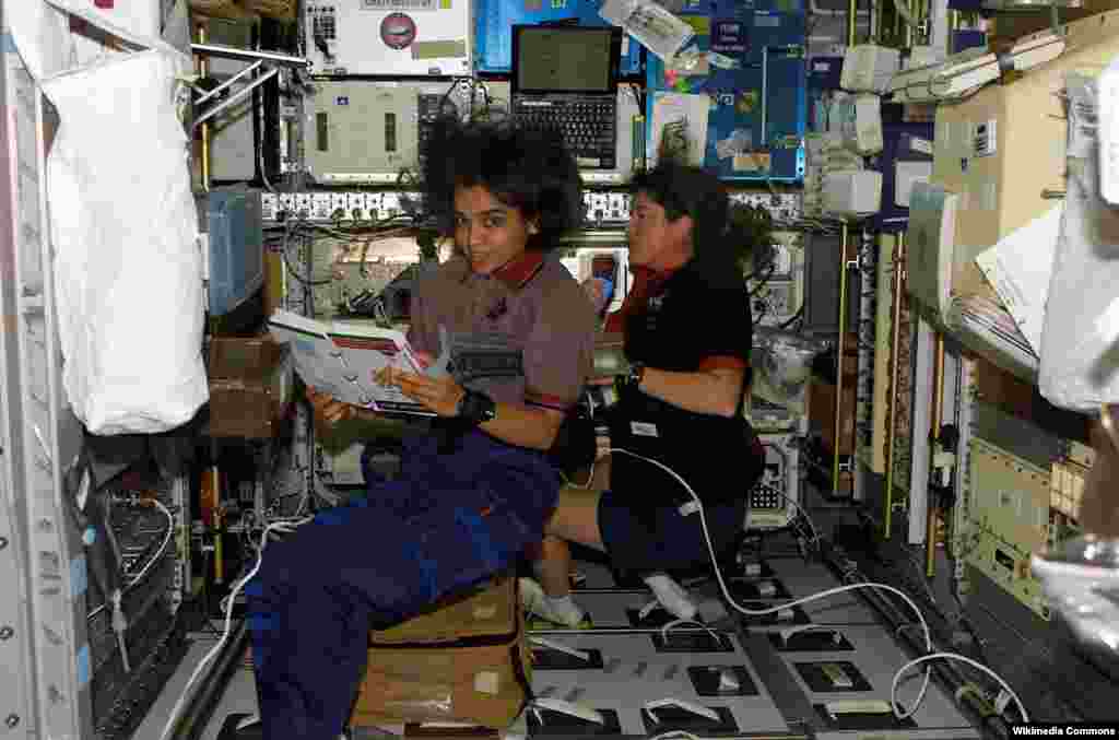 Indian-American Kalpana Chawla (left) and Laurel Clark work aboard the U.S. space shuttle &quot;Columbia&quot; in January 2003, two weeks before it disintegrated on reentry, killing everyone aboard.