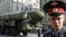 A Russian policeman stands in front of a Topol-M ICBM during a rehearsal for the Victory Day parade in Moscow in May 2008.