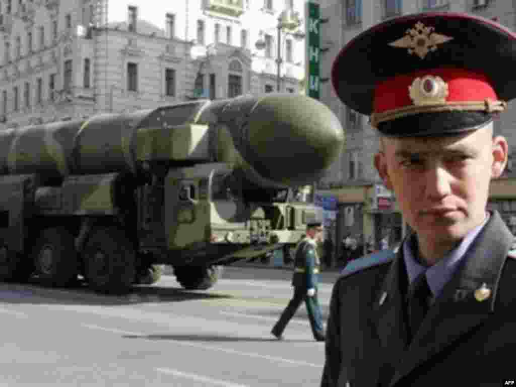 A policeman stands guard in front of a Topol-M - Tanks and weapons, such as the Topol-M intercontinental ballistic missile, will be on display for the Russian public, most of whom grew up in the era of extravagant Soviet military exhibitions.