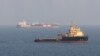  A handout photographer released by the British Ministry of Defence on September 28, 2019 shows the UAE-flagged Offshore Support Vessel Mubarak Spirit (R) sailing in front of British-flagged oil tanker Stena Impero after its release by Iran.