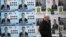 BULGARIA -- A woman walks past election posters of the ruling centre-right GERB party in the town of Dupnitsa, Bulgaria, April 2, 2021.
