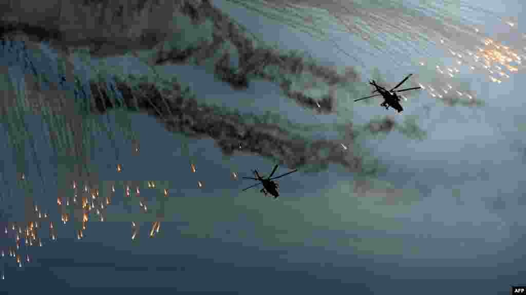 Russian military MI-28 helicopters launch thermal rockets during the Indra-2014 joint Russian-Indian tactical military exercises at the Prudboy firing ground&nbsp;outside the southern city of Volgograd. (AFP/Andrew Mireyko) 