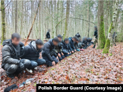 Migrants intercepted by Polish border guards after around 180 mostly Pakistani and Afghan nationals emerged from a tunnel near Narewka in December 2025.
