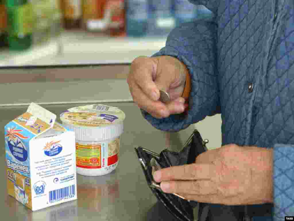 Food prices rising - A shopper pays for food at a store in Vladivostok, February 22.