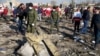 Security officers and Red Crescent workers inspect the site where the Ukraine International Airlines Flight PS752 crashed after takeoff from Iran's Imam Khomeini Airport on the outskirts of Tehran on January 8, 2020. 