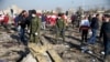 FILE PHOTO: Security officers and Red Crescent workers are seen at the site where the Ukraine International Airlines plane shot down after take-off from Iran's Imam Khomeini airport, on the outskirts of Tehran, Iran January 8, 2020. 