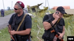 Ukraine -- Pro-Russian armed rebels guard the debris at the main crash site of the Boeing 777 Malaysia Airlines flight MH17, which crashed during flying over the eastern Ukraine region, near Hrabovo, 20 July 2014