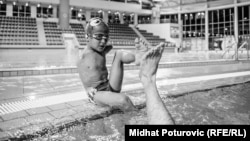 Disabled Bosnian swimmer Ismail Zulfic gives his trainer a high-five