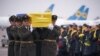 Soldiers carry a coffin containing the remains of one of the eleven Ukrainian victims of flight 752 during a memorial ceremony at the Boryspil International Airport, outside Kyiv, Ukraine January 19, 2020