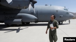 An Afghan Air Force pilot checks a C-130 military transport plane before a flight in Kabul in July.